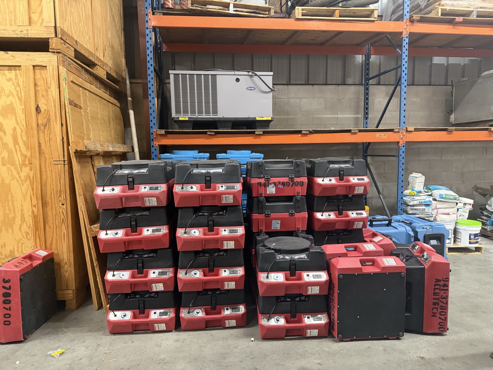 Stack of commercial LGR dehumidifiers in Accutech's Sarasota warehouse, ready for emergency deployment